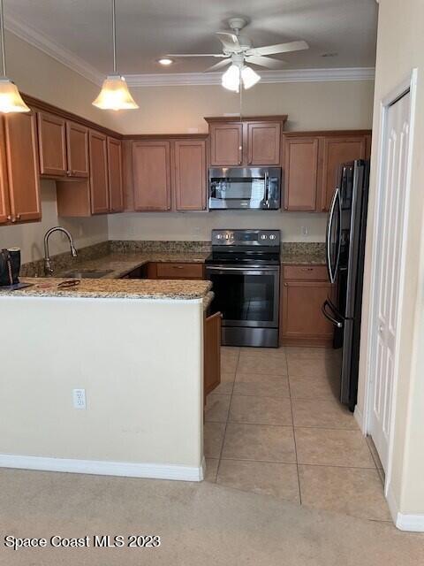 3551 Funston Circle Melbourne, FL 32940 - Photo 12 of 25 a kitchen with stainless steel appliances granite countertop a stove a sink and a refrigerator