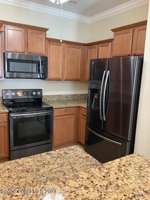 3551 Funston Circle Melbourne, FL 32940 - Photo 14 of 25 a kitchen with granite countertop a refrigerator stove and microwave