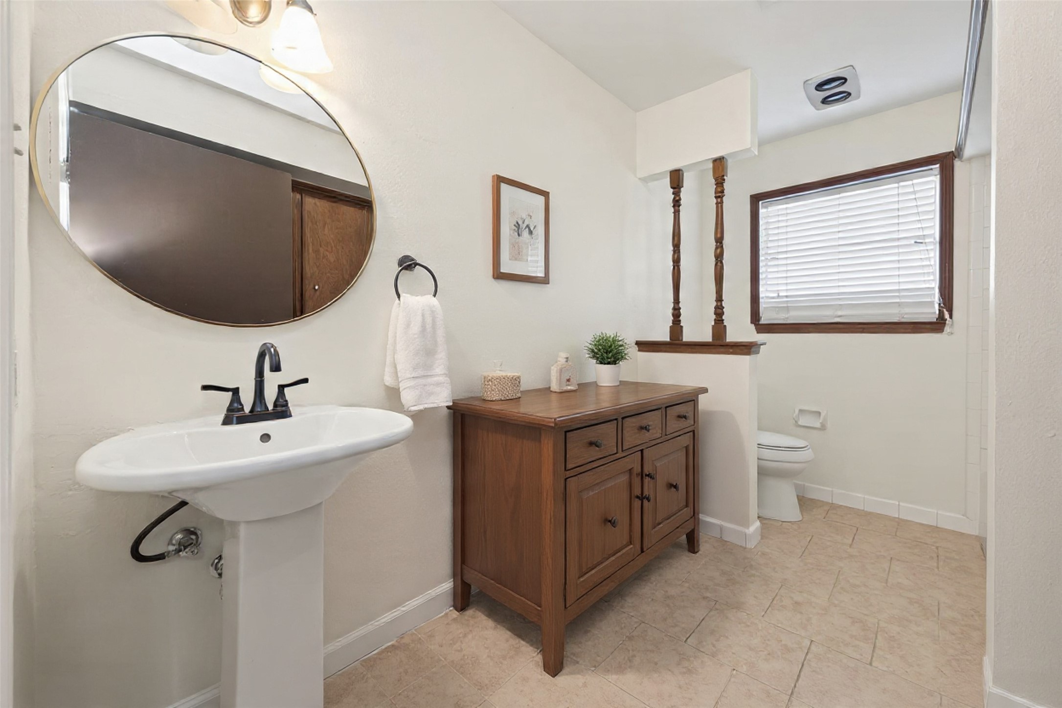 1010 Rhine Lane Houston, TX 77090 - Photo 17 of 30 a bathroom with a toilet sink and mirror