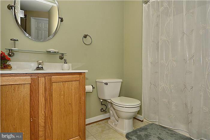 14222 Autumn Gold Road Boyds, MD 20841 - Photo 22 of 29 a bathroom with a toilet a sink and mirror