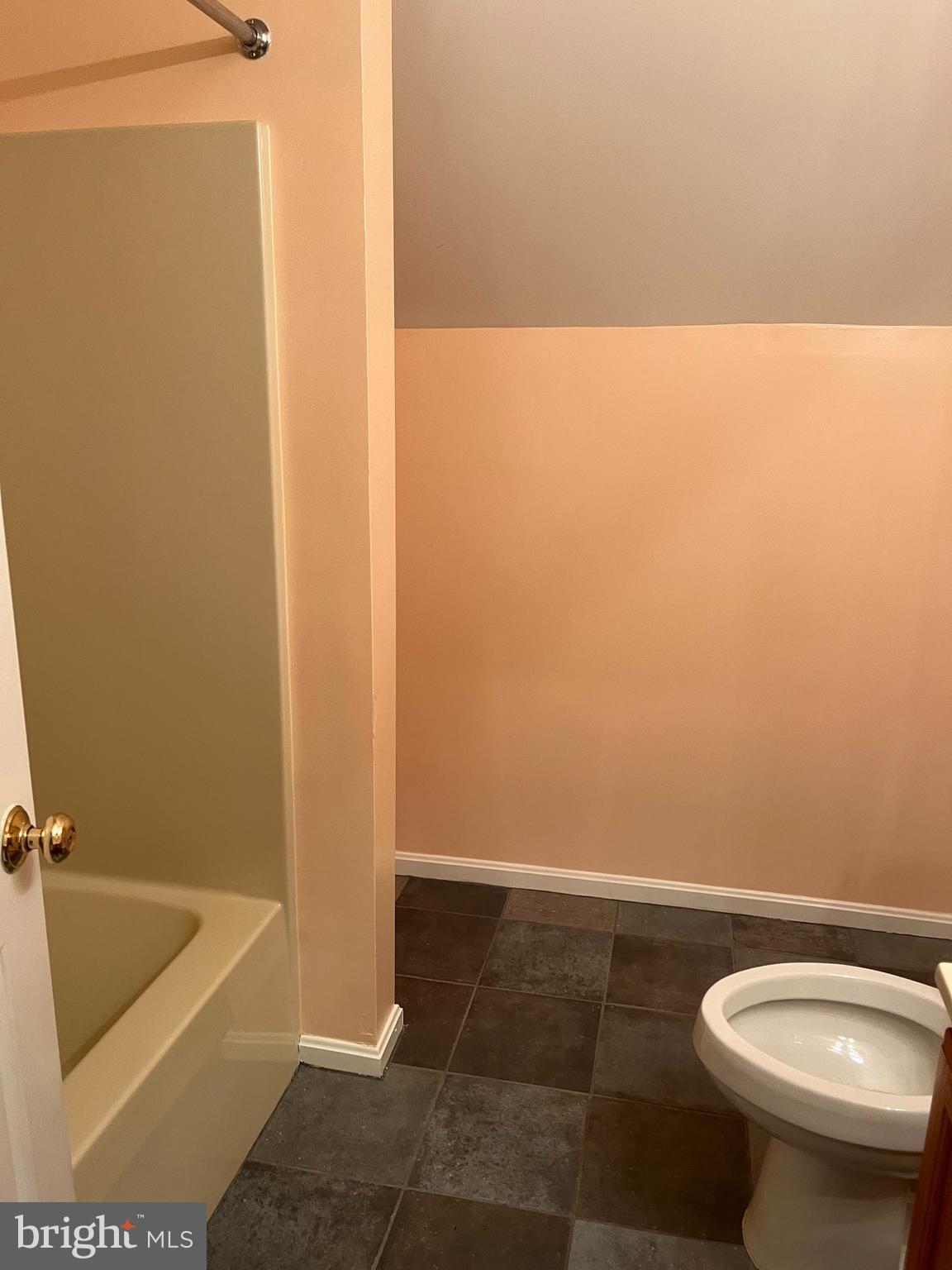 7502 Contee Road Laurel, MD 20707 - Photo 14 of 18 a bathroom with a toilet and a bathtub