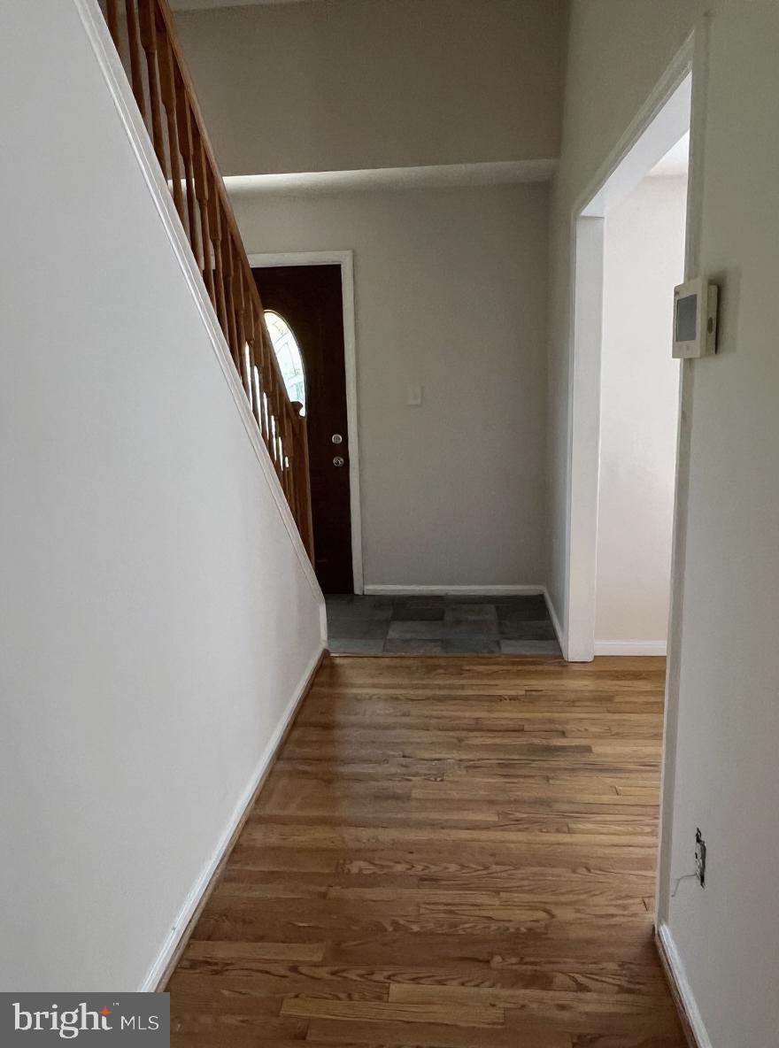 7502 Contee Road Laurel, MD 20707 - Photo 2 of 18 a view of a hallway with wooden floor and staircase