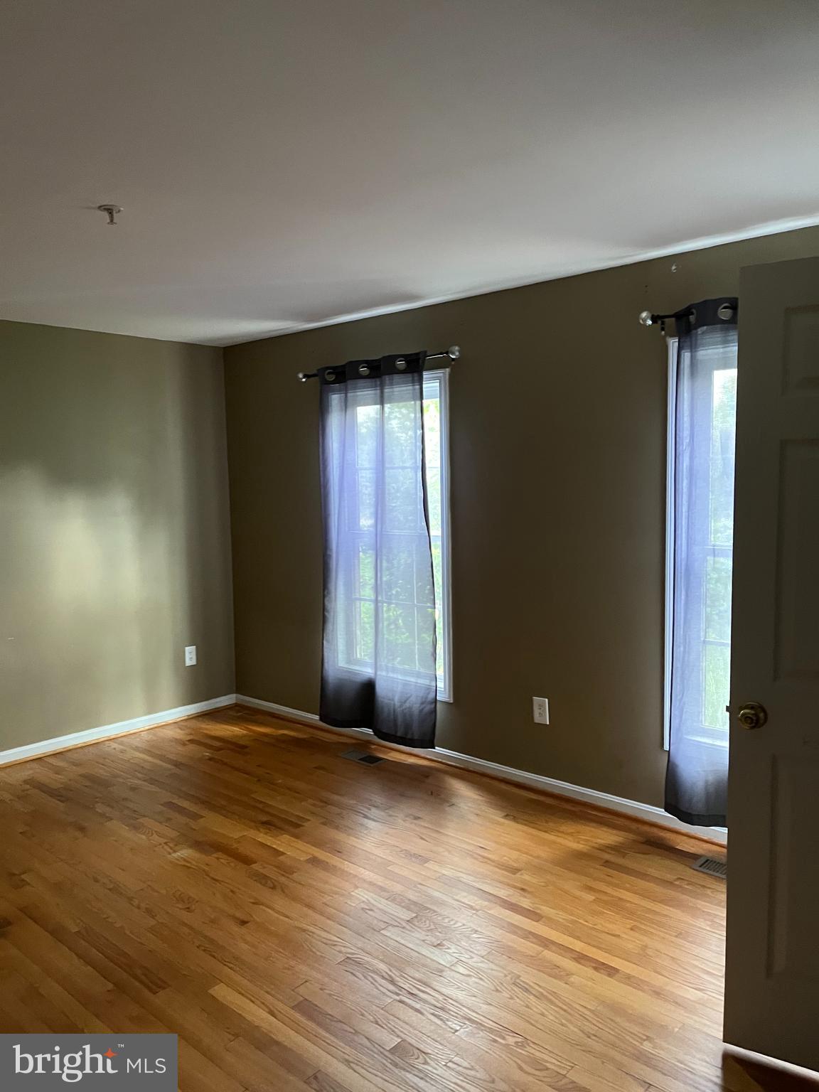 7502 Contee Road Laurel, MD 20707 - Photo 8 of 18 a view of an empty room with window and wooden floor