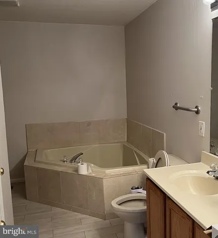 a bathroom with a sink a toilet and bathtub