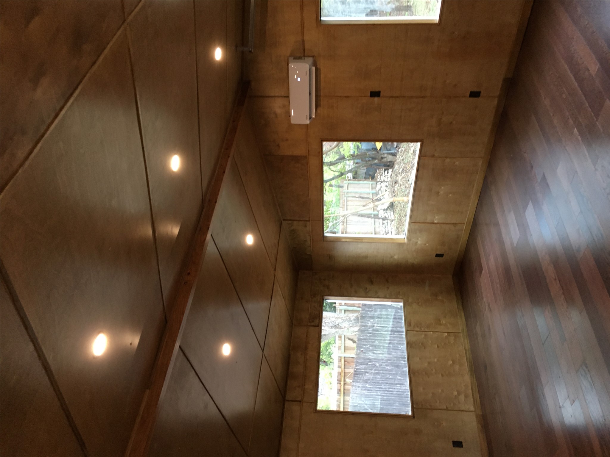 5405 Hudson Street Austin, TX 78721 - Photo 33 of 37 Rich hardwood flooring complements the natural wood paneling and recessed lighting in this versatile space.