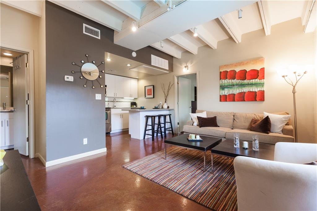 2408 Leon Street, Unit 303 Austin, TX 78705 - Photo 3 of 10 a living room with lots of furniture and kitchen view