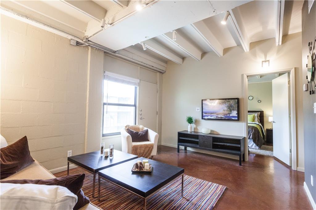 2408 Leon Street, Unit 303 Austin, TX 78705 - Photo 4 of 10 a living room with furniture a rug and a window