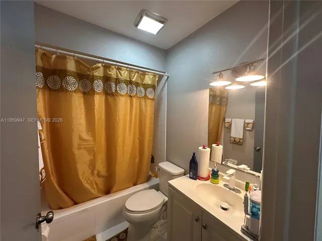 a bedroom with a bed window and dresser