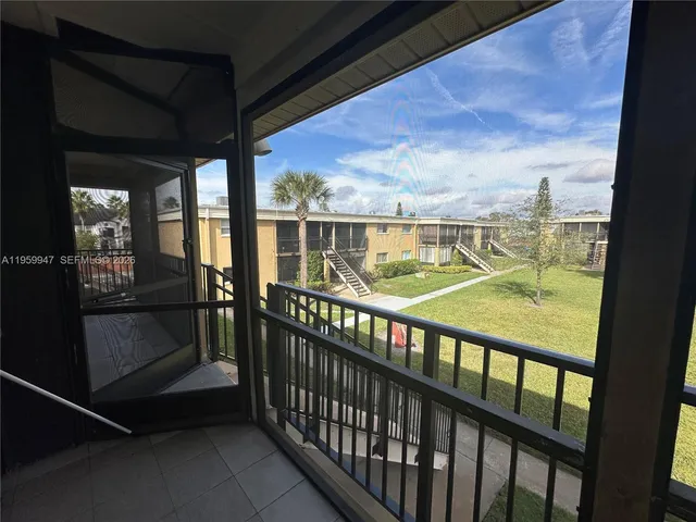 a view of a house with a yard table and chairs