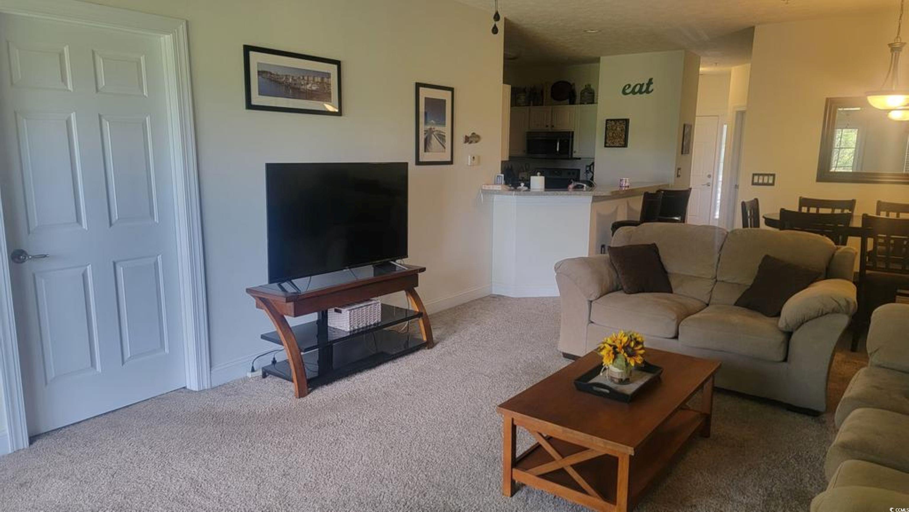 6000 Windsor Green Way, Unit 11202 Myrtle Beach, SC 29579 - Photo 3 of 10 Living area with light carpet and baseboards
