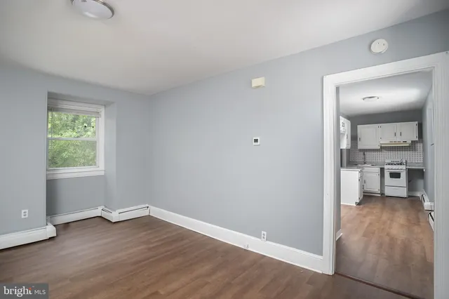 wooden floor in an empty room and a kitchen