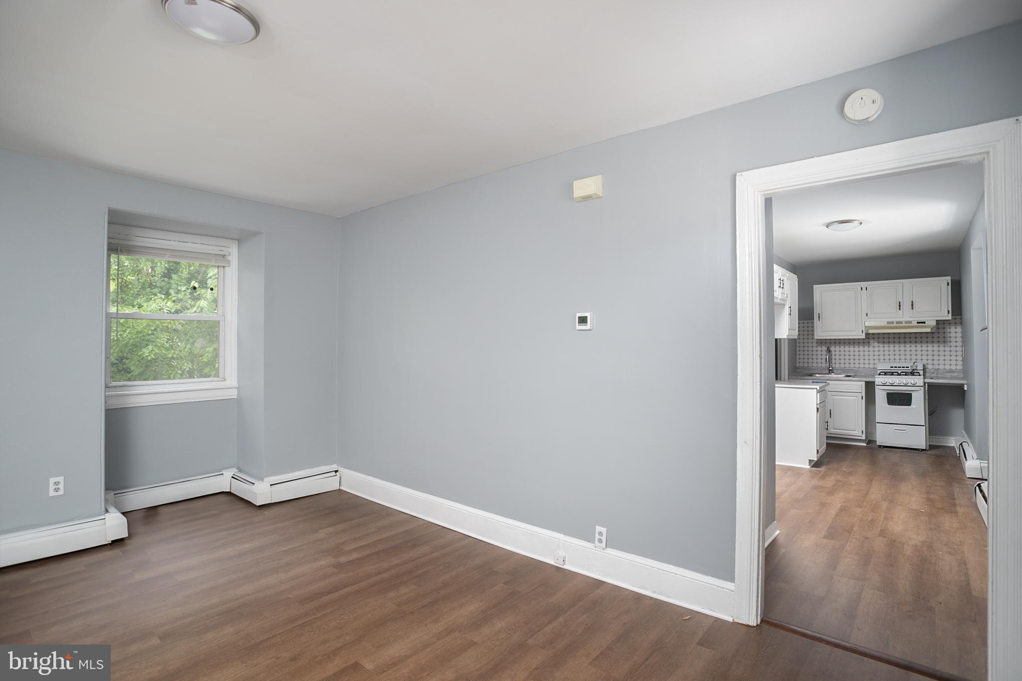 117 East Walnut Avenue, Unit E Merchantville, NJ 08109 - Photo 6 of 22 wooden floor in an empty room and a kitchen