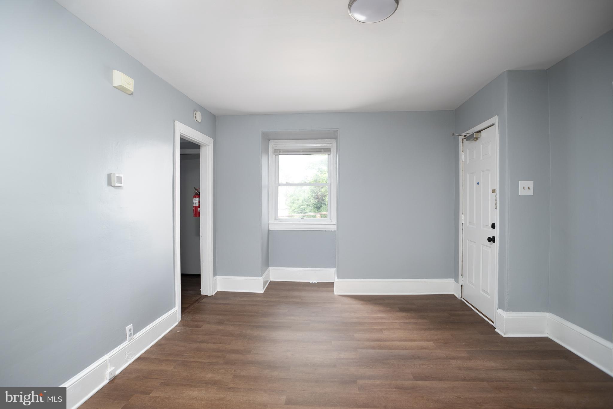 117 East Walnut Avenue, Unit E Merchantville, NJ 08109 - Photo 7 of 22 a view of an empty room with wooden floor and a window