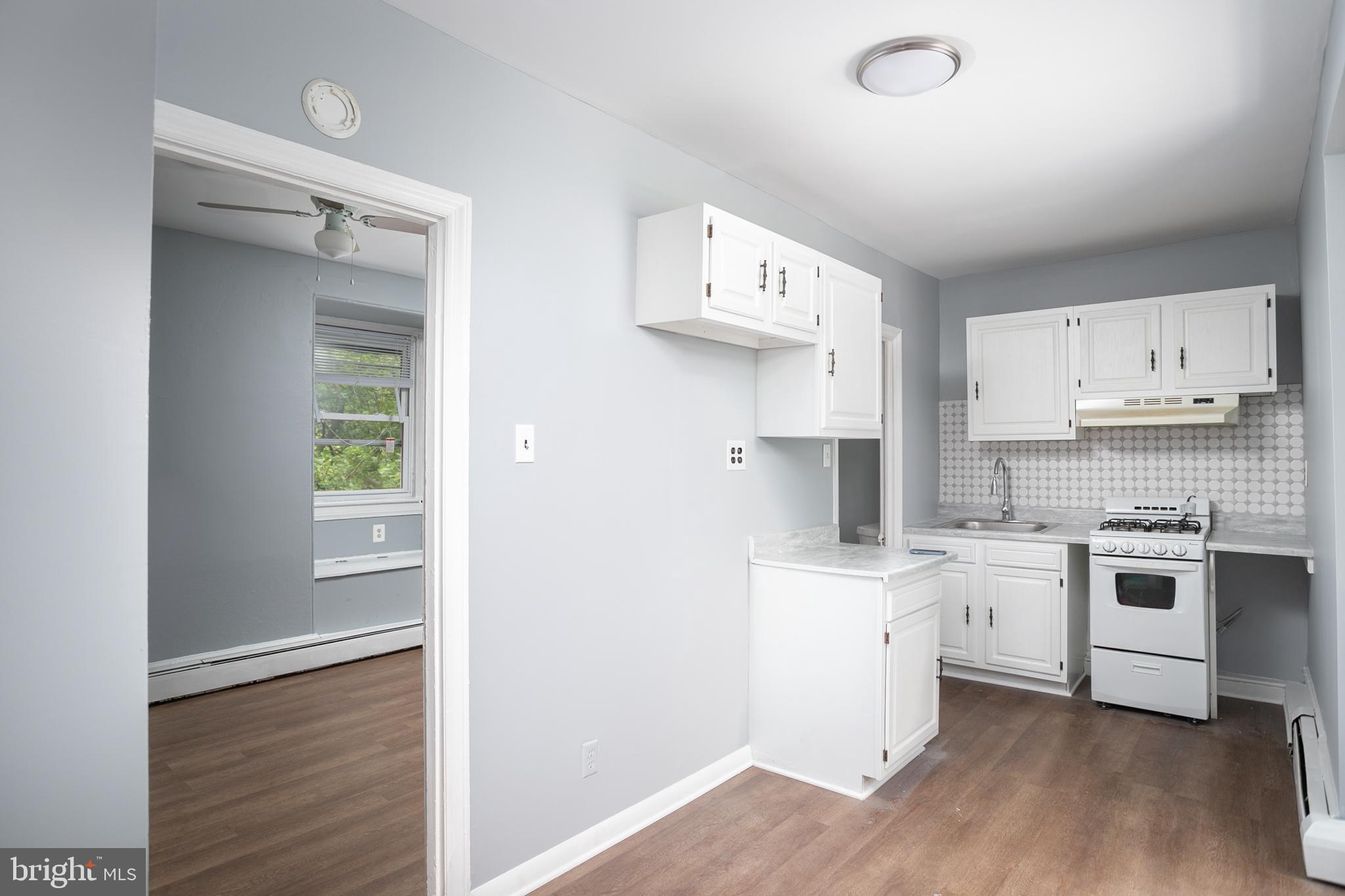 117 East Walnut Avenue, Unit E Merchantville, NJ 08109 - Photo 9 of 22 a kitchen with a sink a stove and cabinets
