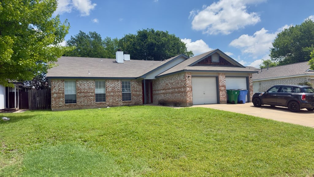 2306 Fuzz Fairway, Unit A Austin, TX 78728 - Photo 1 of 20 Brick exterior with a shingle roof and a two-car garage