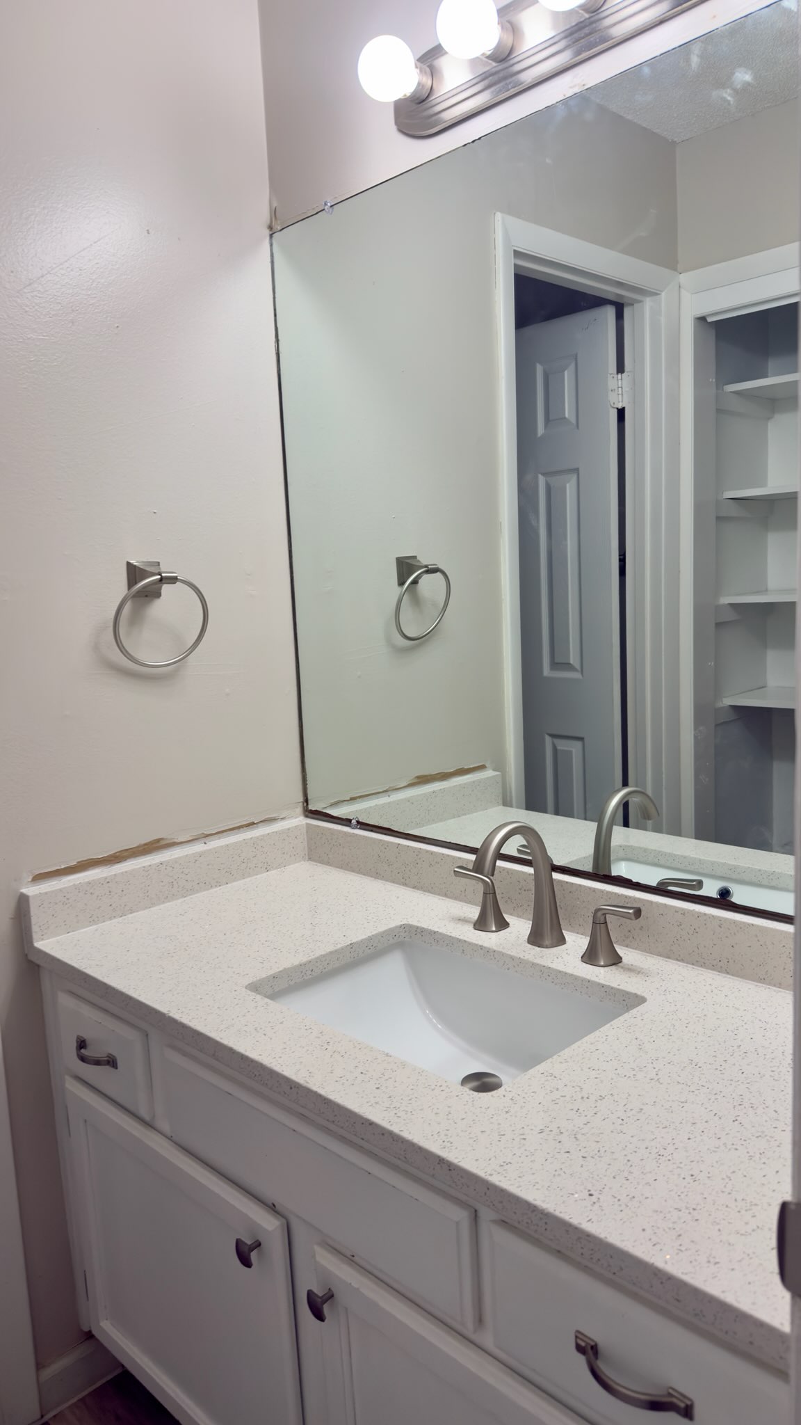 2306 Fuzz Fairway, Unit A Austin, TX 78728 - Photo 18 of 20 Bathroom vanity featuring a light-toned countertop, integrated sink, and brushed nickel fixtures