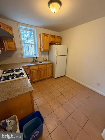 a kitchen that has a sink and a stove in it