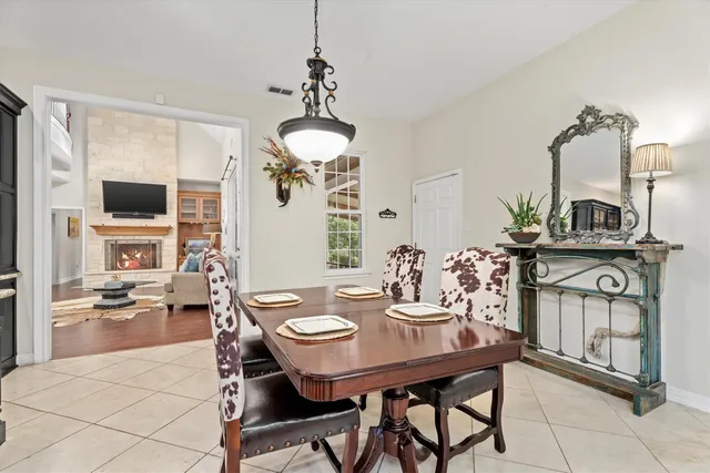 a view of a dining room with furniture a chandelier and wooden floor