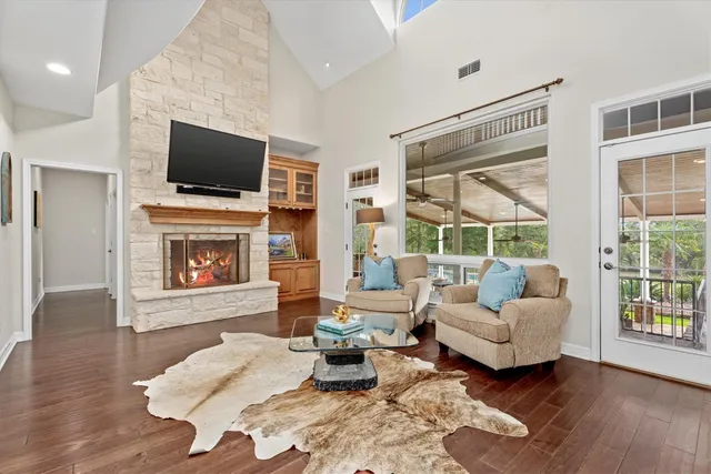 a living room with furniture fireplace and flat screen tv