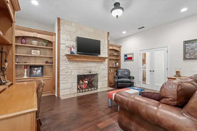 a living room with furniture fireplace and flat screen tv