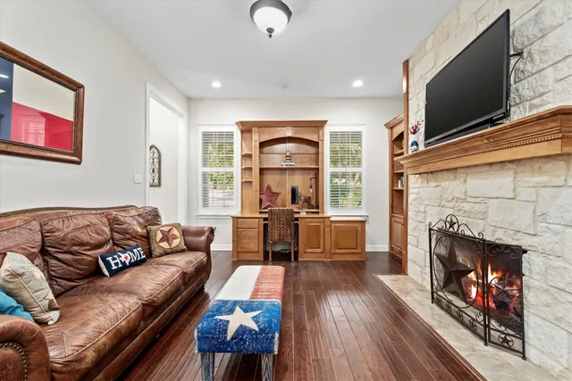 a living room with furniture fireplace and flat screen tv