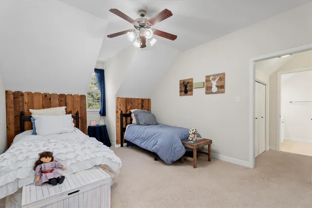 a bedroom with two beds and a chandelier