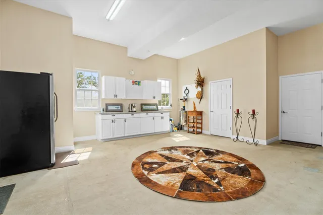 a view of a kitchen with refrigerator and wooden floor