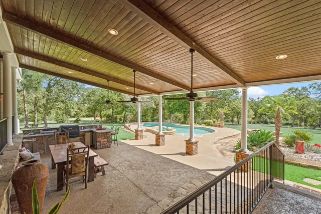 a view of a patio with chairs and floor to ceiling window