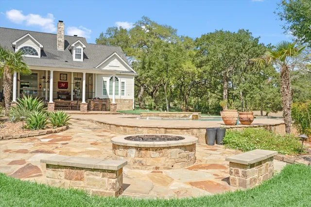 a view of a house with backyard porch and sitting area