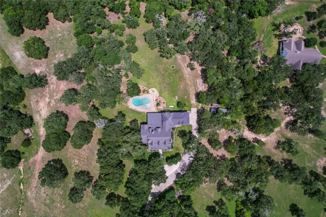 an aerial view of residential house with outdoor space and swimming pool