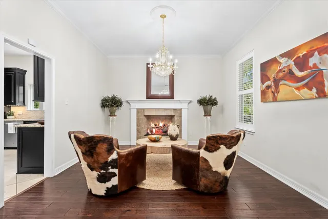a living room with furniture and a chandelier