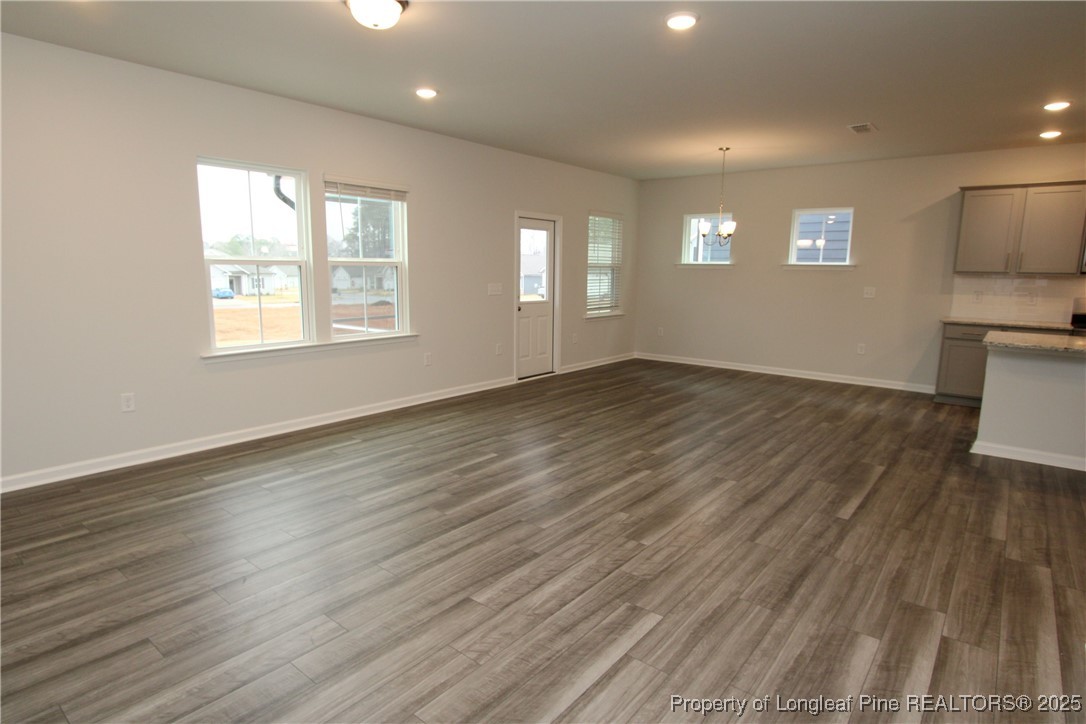 461 Grange Farm Place Raleigh, NC 27603 - Photo 12 of 50 an empty room with wooden floor and windows