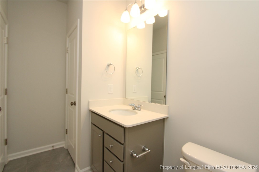 461 Grange Farm Place Raleigh, NC 27603 - Photo 18 of 50 a bathroom with a sink toilet and mirror
