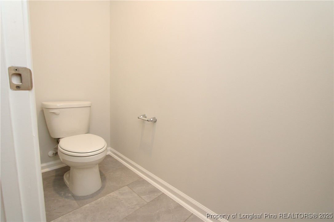 461 Grange Farm Place Raleigh, NC 27603 - Photo 25 of 50 a white toilet sitting next to a white wall