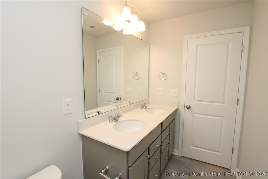 461 Grange Farm Place Raleigh, NC 27603 - Photo 30 of 50 a bathroom with a sink vanity and a mirror