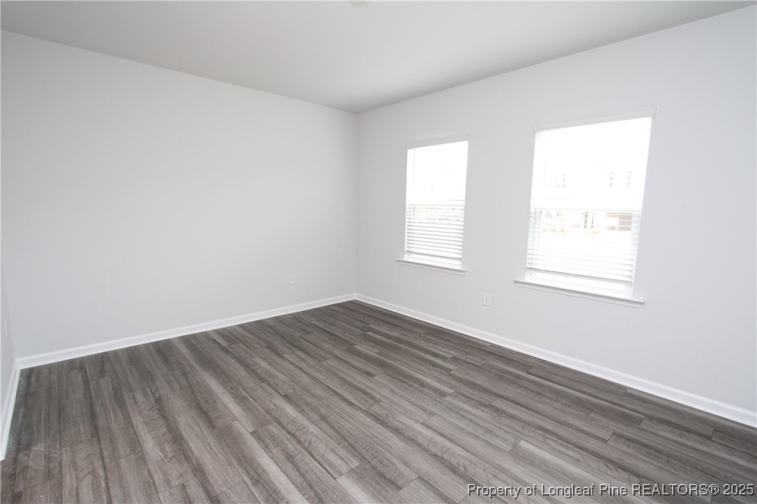 461 Grange Farm Place Raleigh, NC 27603 - Photo 3 of 50 an empty room with wooden floor and windows