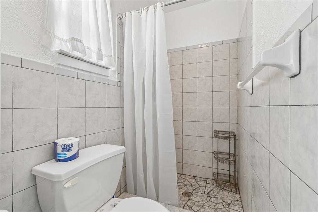 6634 Manor Beach Road New Port Richey, FL 34652 - Photo 25 of 64 a bathroom with a toilet and shower