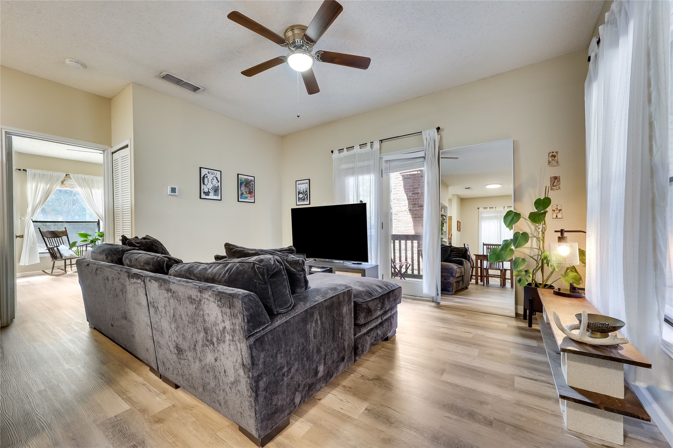 3011 Fruth Street, Unit 101 Austin, TX 78705 - Photo 4 of 14 An inviting living room features durable plank flooring and a private balcony.
