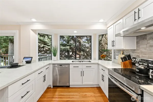 a kitchen with a sink stove and cabinets