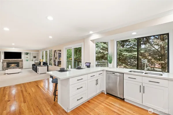 a large white kitchen with a large window