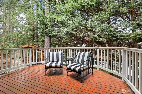 a view of balcony with wooden floor and fence