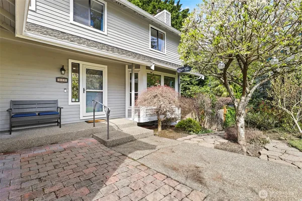 a view of a house with backyard and sitting area