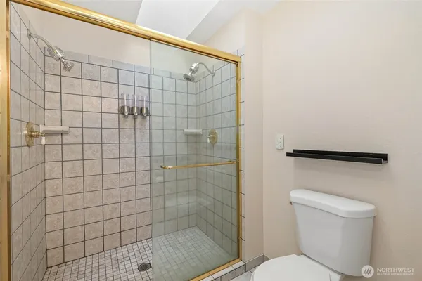 a bathroom with a toilet and a shower