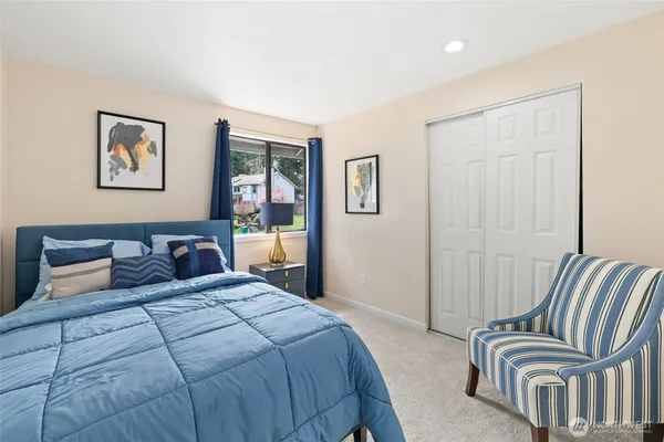 a bedroom with a bed and a painting on the wall