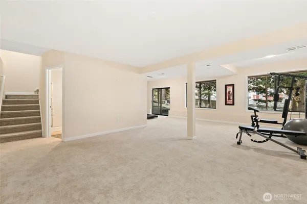a view of a livingroom with furniture and a large window