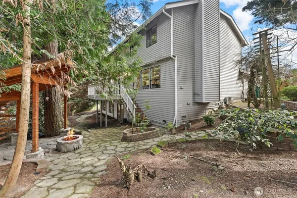a backyard of a house with table and chairs