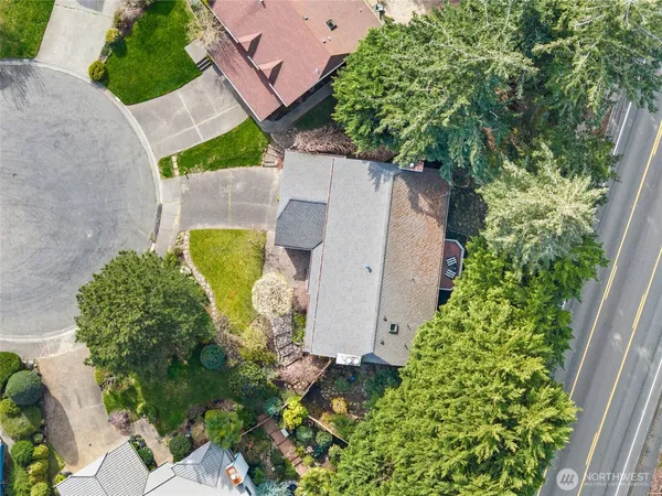 an aerial view of a house with a yard and a basket ball court