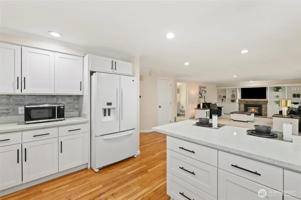 a kitchen with white cabinets and stainless steel appliances