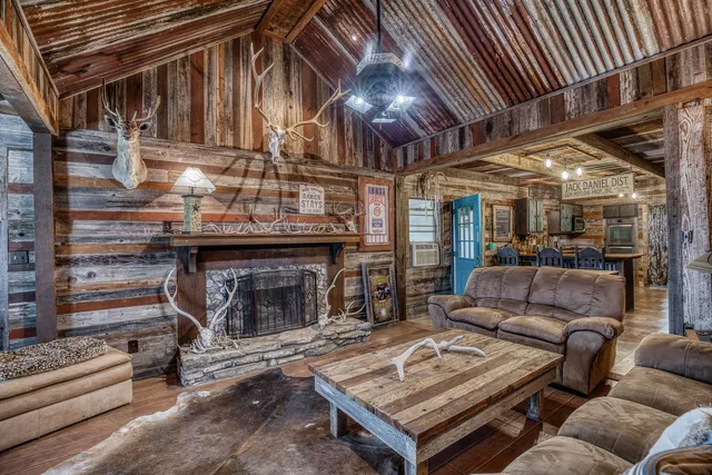 a living room with furniture a fireplace and wooden floor