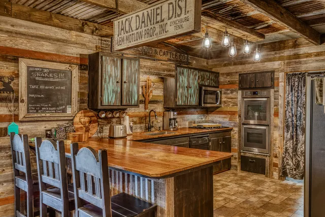 a kitchen with stainless steel appliances granite countertop a sink and wooden cabinets